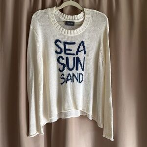 Wooden ships sea sun sand sweater